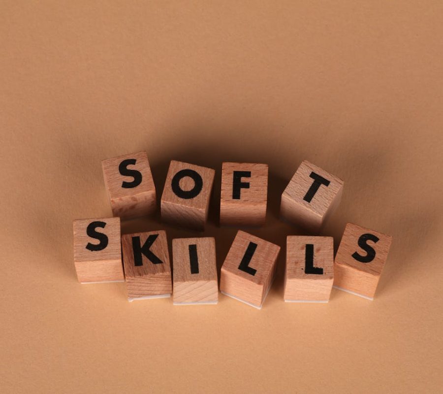 Wooden letter blocks spell out 'Soft Skills', highlighting business and personal development concepts.